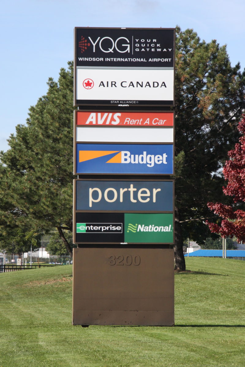 YQG Car Rental Services Sign